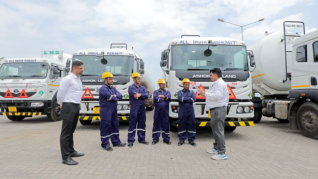 Oraya Gas crew in safety gear with LNG tankers